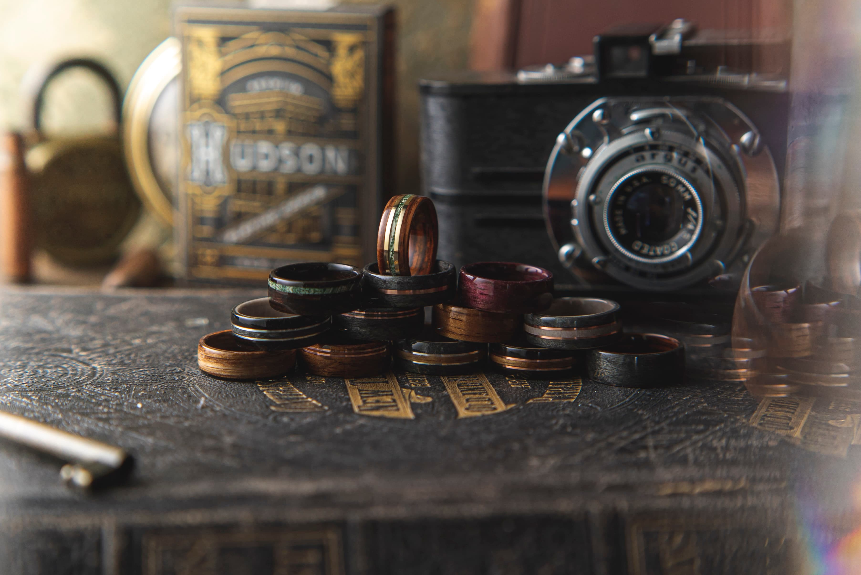 Pile of handcrafted Ring + Grove wooden wedding bands